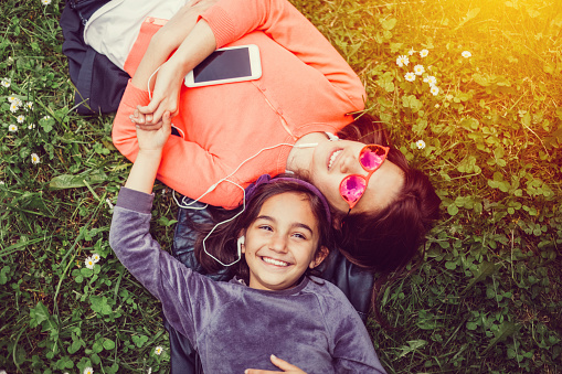 Relaxed girls sunbathing in the park